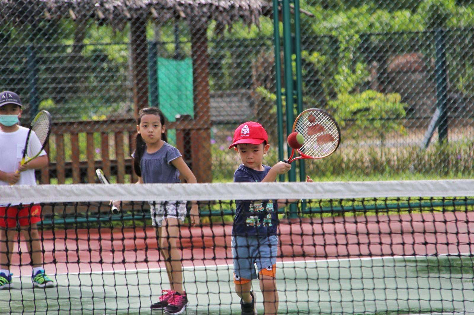 two kids playing tennis