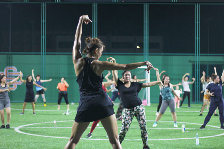 Group of people participating in a Zumba class