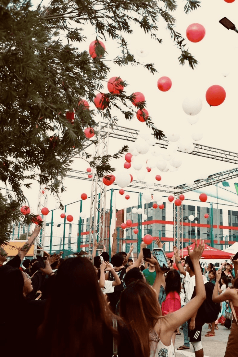 a group of people with balloons in the air