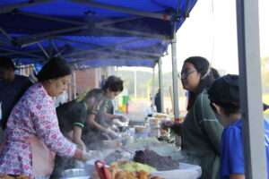 a person and person at a food stand