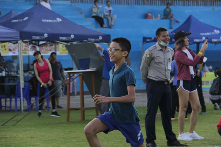 a young boy running on a field