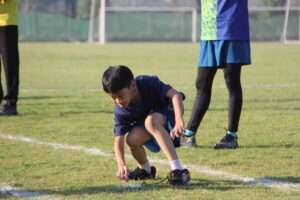 a child picking up a potato on a field