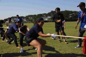 a group of people playing tug of war