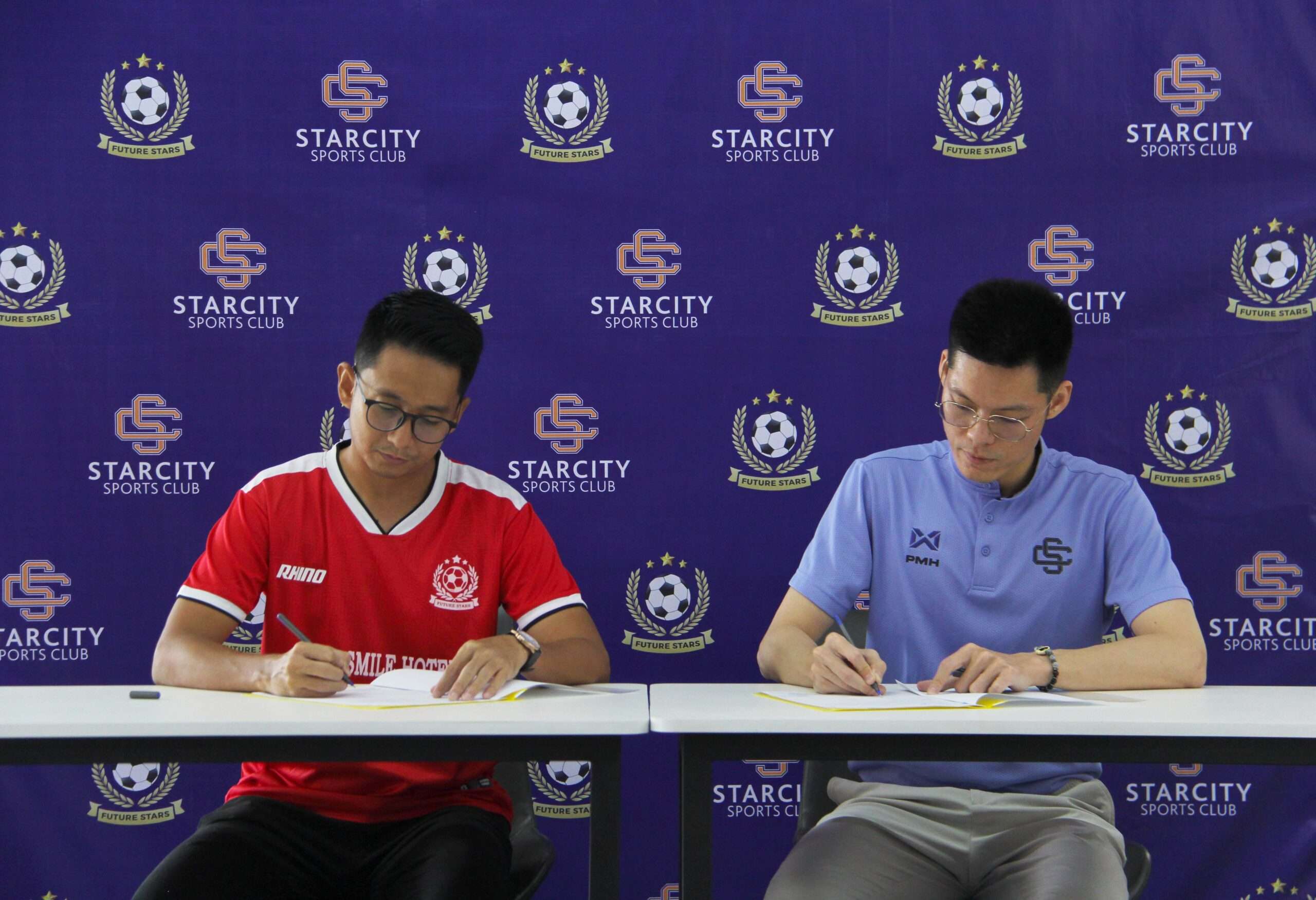 two people signing the documents