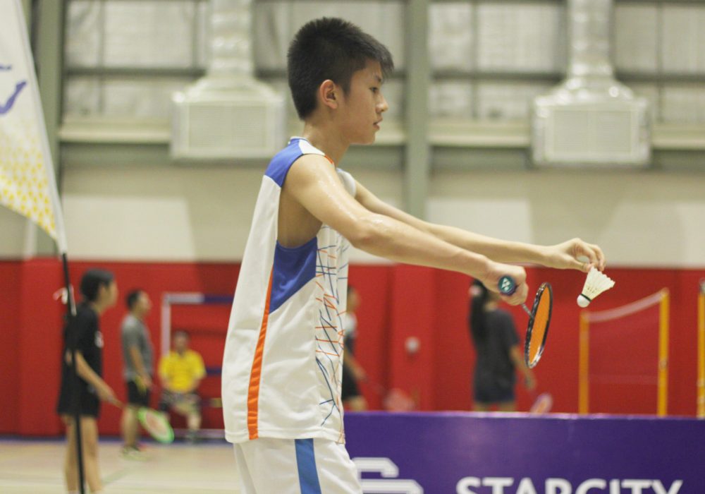 a tennager playing badminton