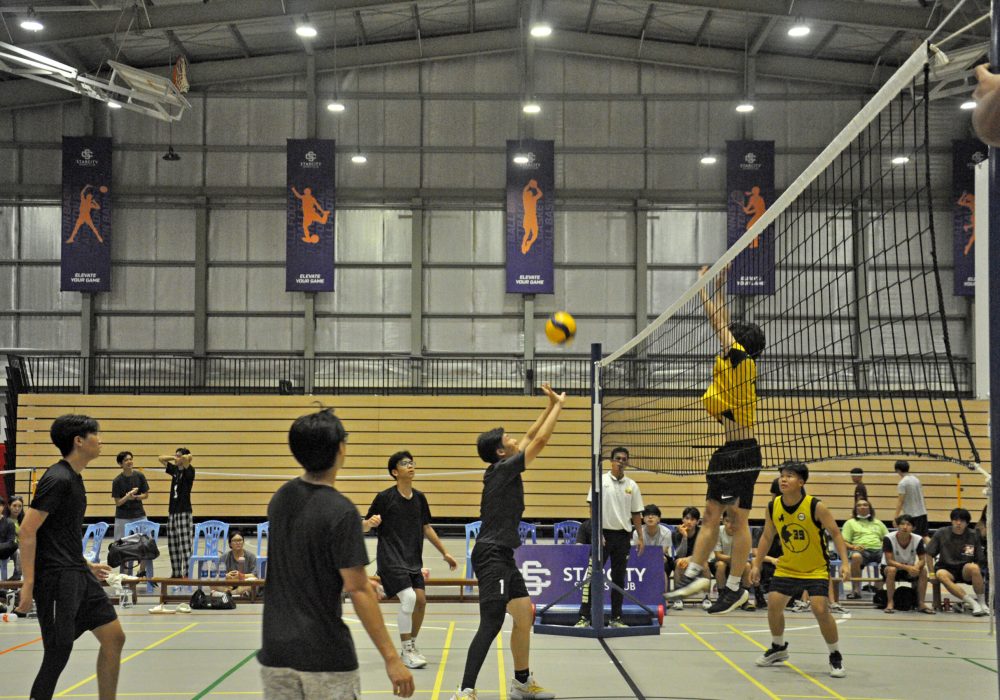 a group of young people playing volleyball