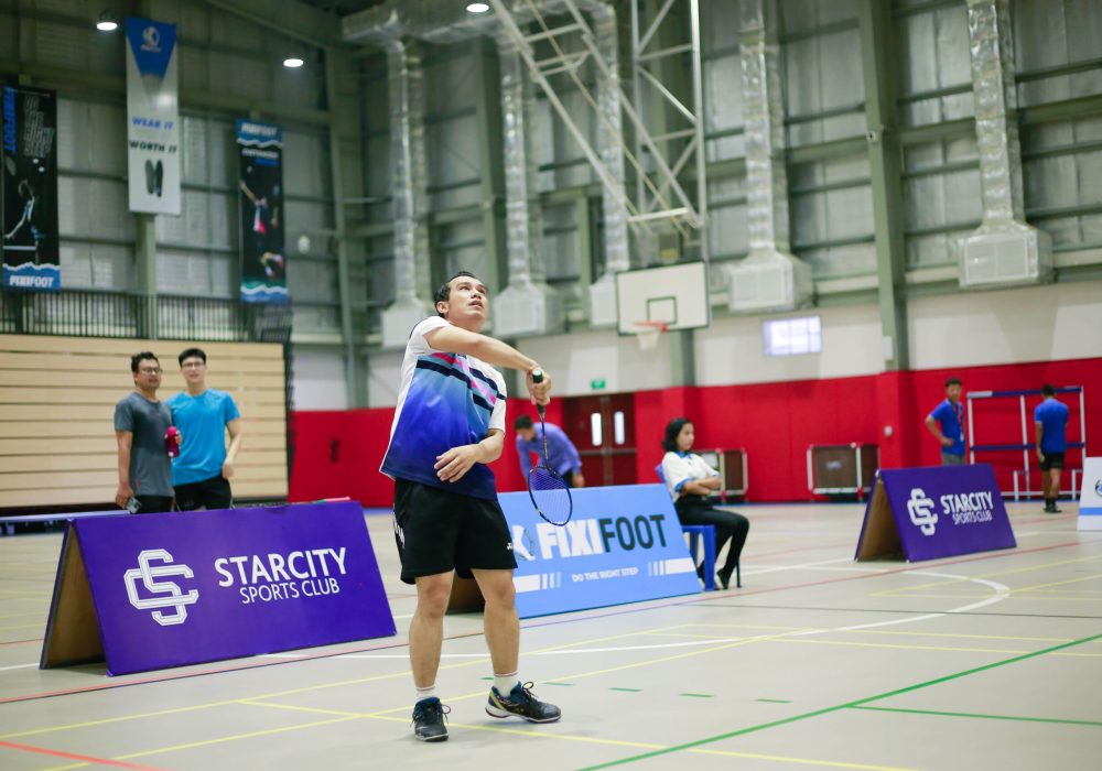 a man playing badminton