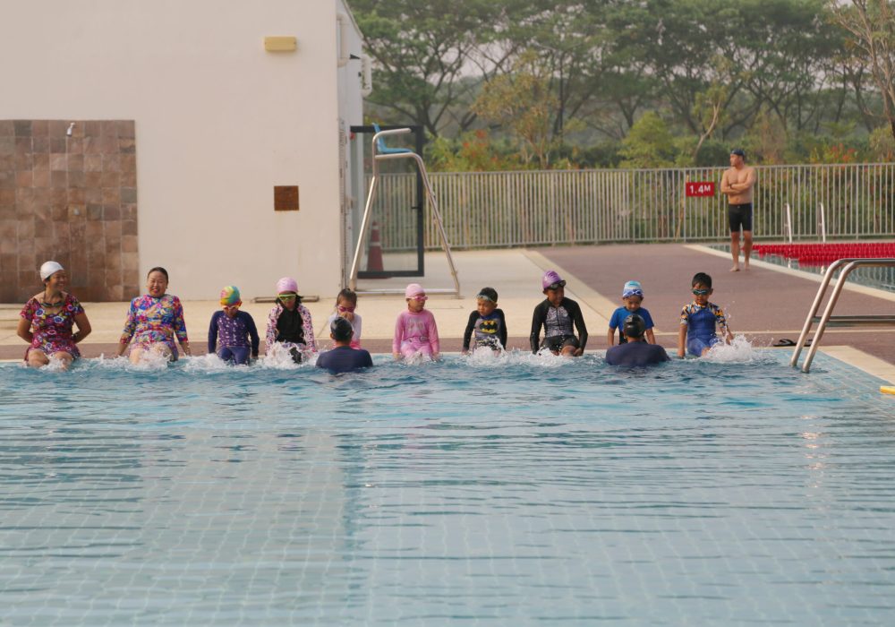 a group of people swimming in training pool