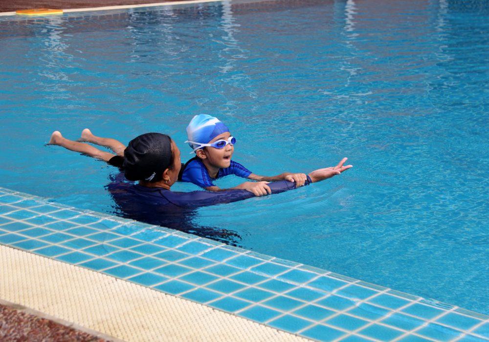 an swimming instructor teaching how to swim